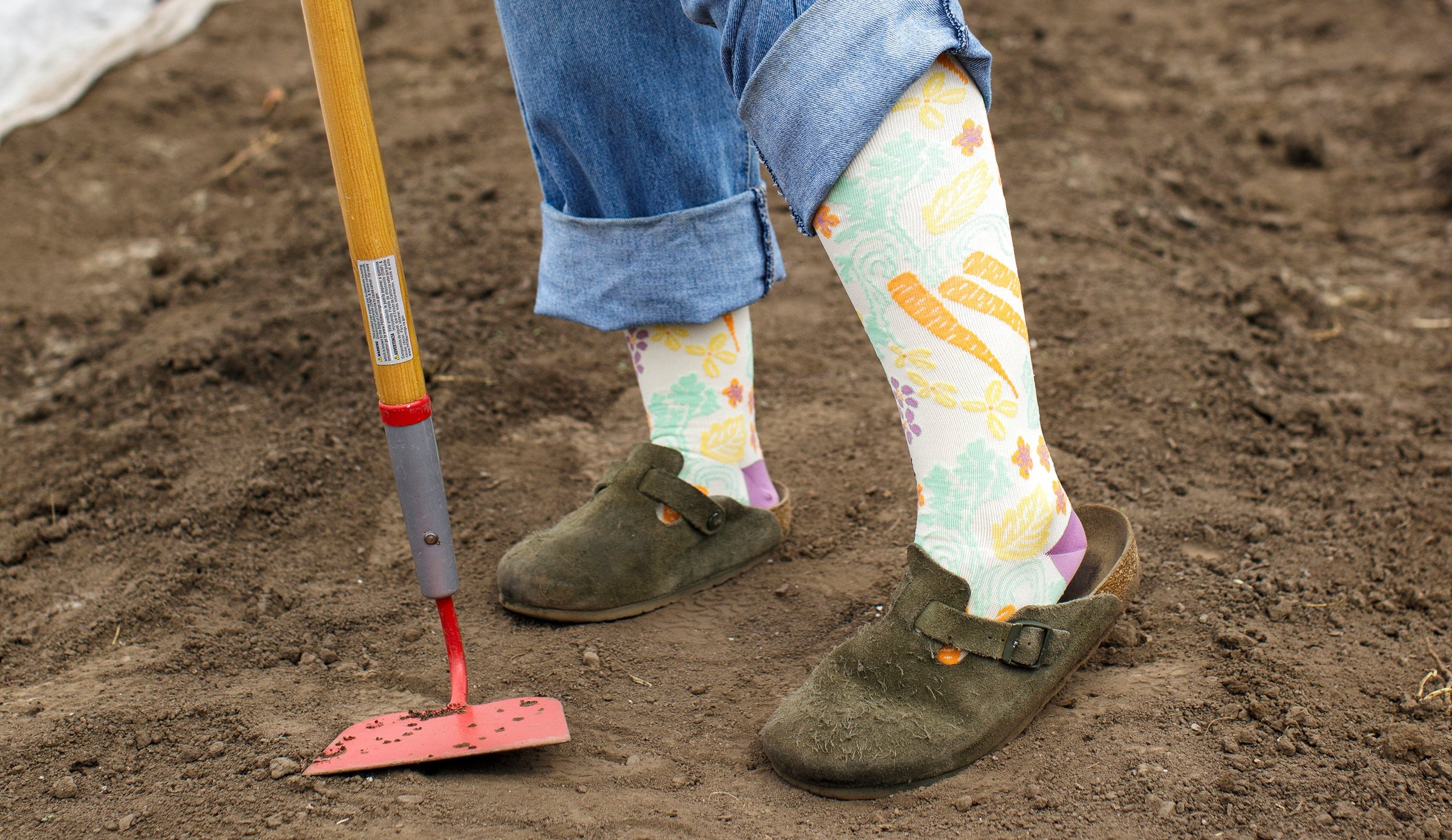 woman wearing compression socks while prepping the soil