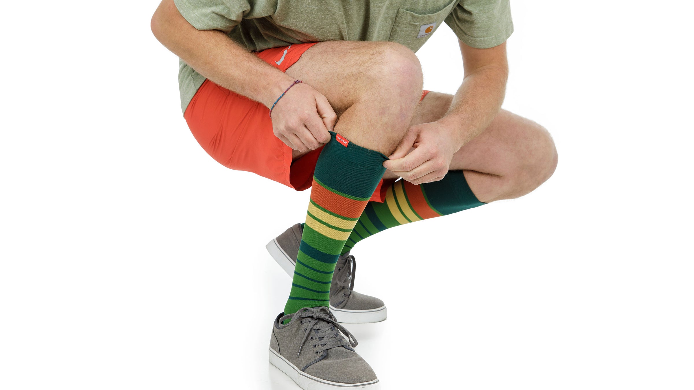 man wearing compression socks while riding a gym bicycle