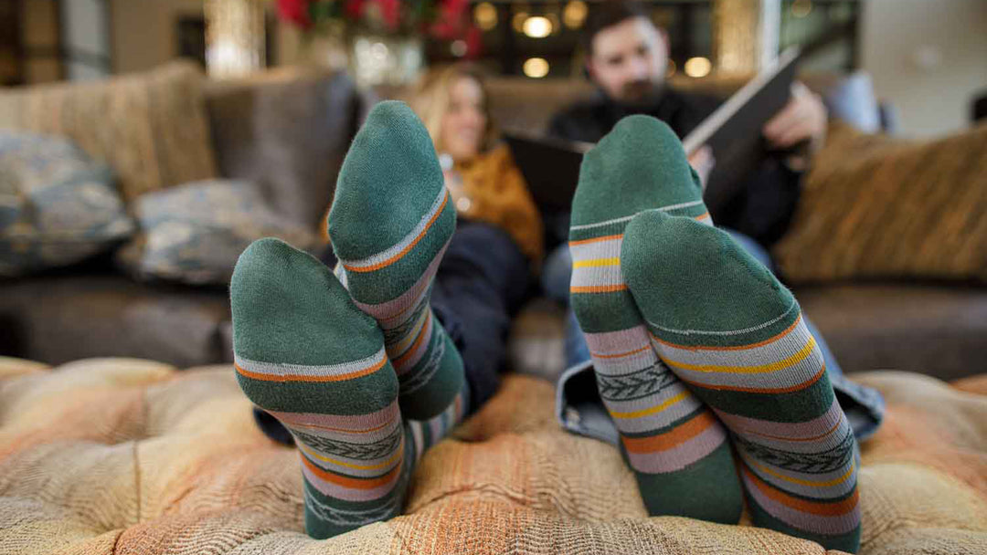 couple on couch wearing compression socks