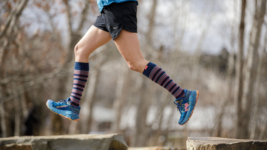 woman wearing compression socks while jogging