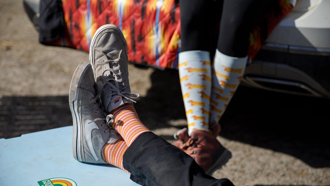two women wearing compression socks outdoors.