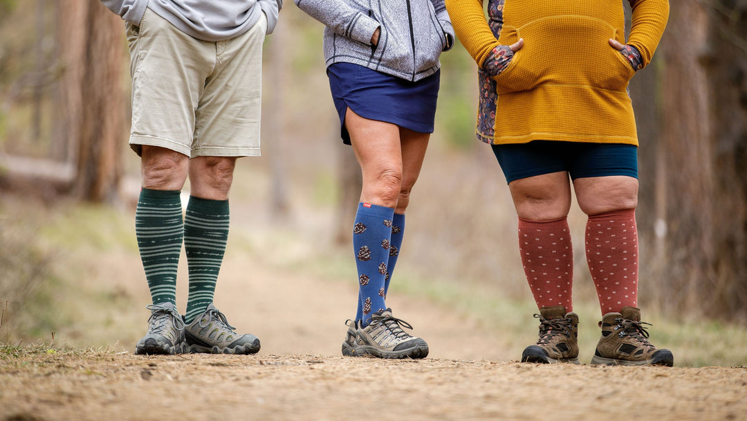 man and two women standing wearing compression socks.