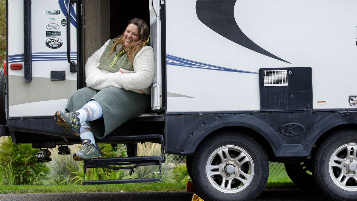 a woman wearing compression socks while sitting on a bus