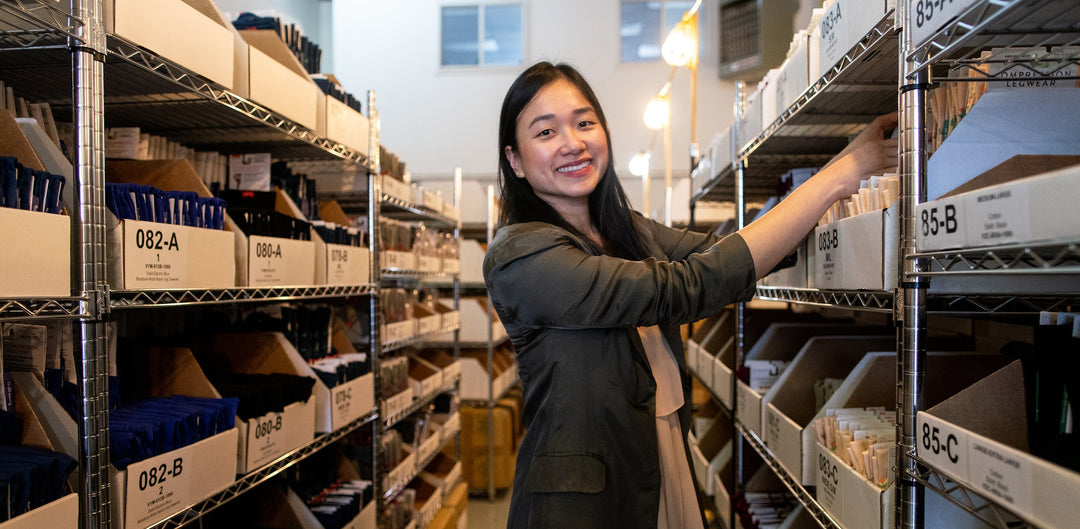VIM & VIGR Compression Socks founder Michelle Huie at the inventory shelves
