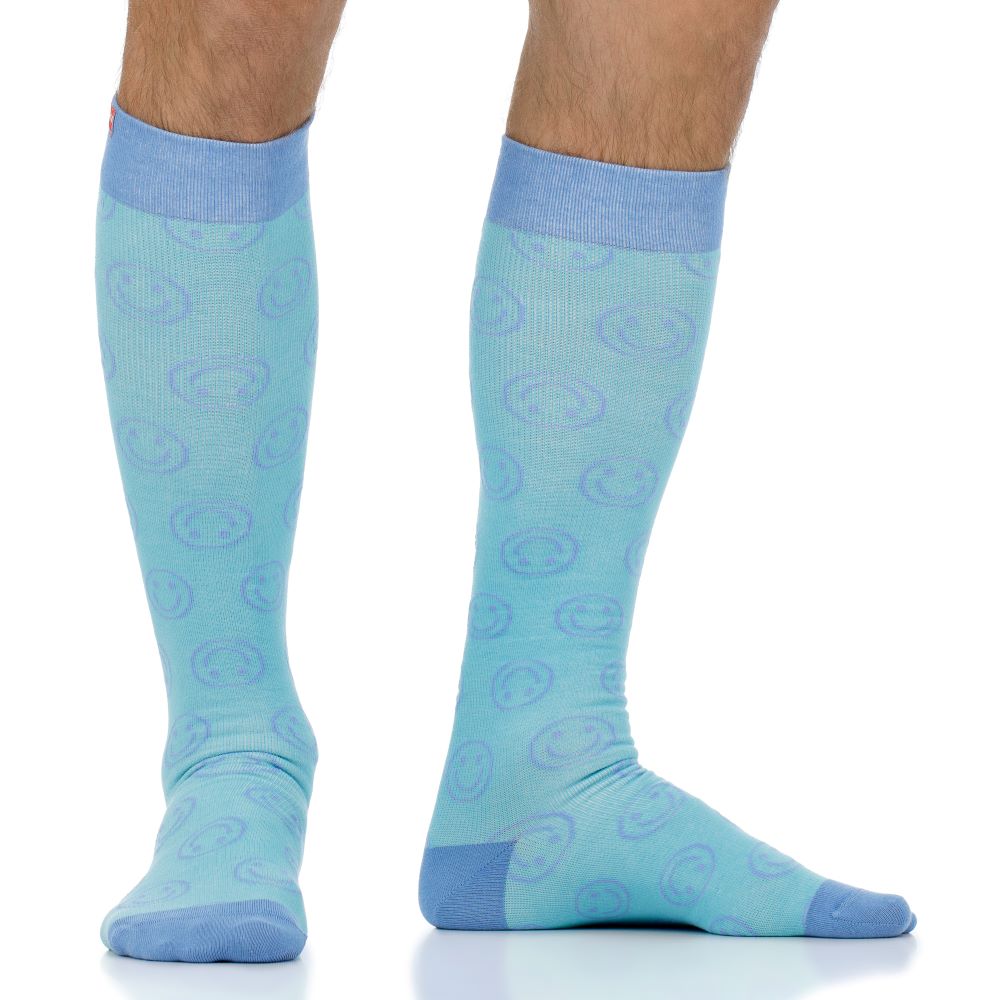 Light blue knee-high socks with a subtle pattern worn by a person on a white background