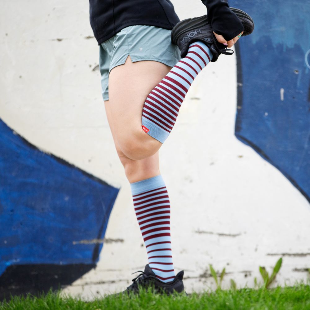 Powder and wine striped compression socks, lifestyle shot