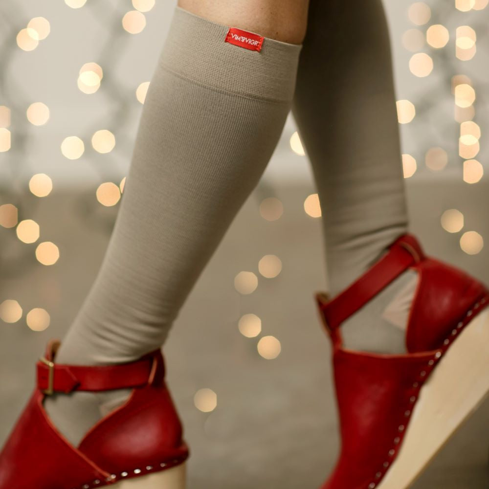 girl posing her Medical-grade 20-30 mmHg: Solid Cashew (Moisture-wick Nylon) compression socks