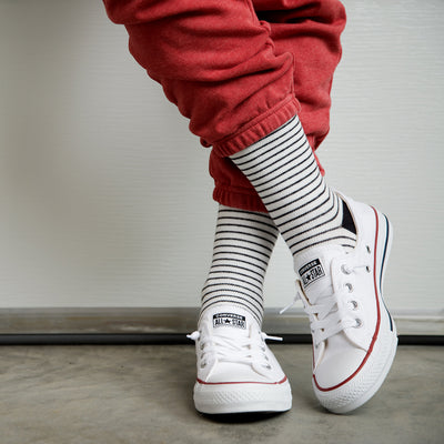girl posing wearing his 30-40 mmHg: Pinstripe Cream & Black (Cotton) Compression Socks
